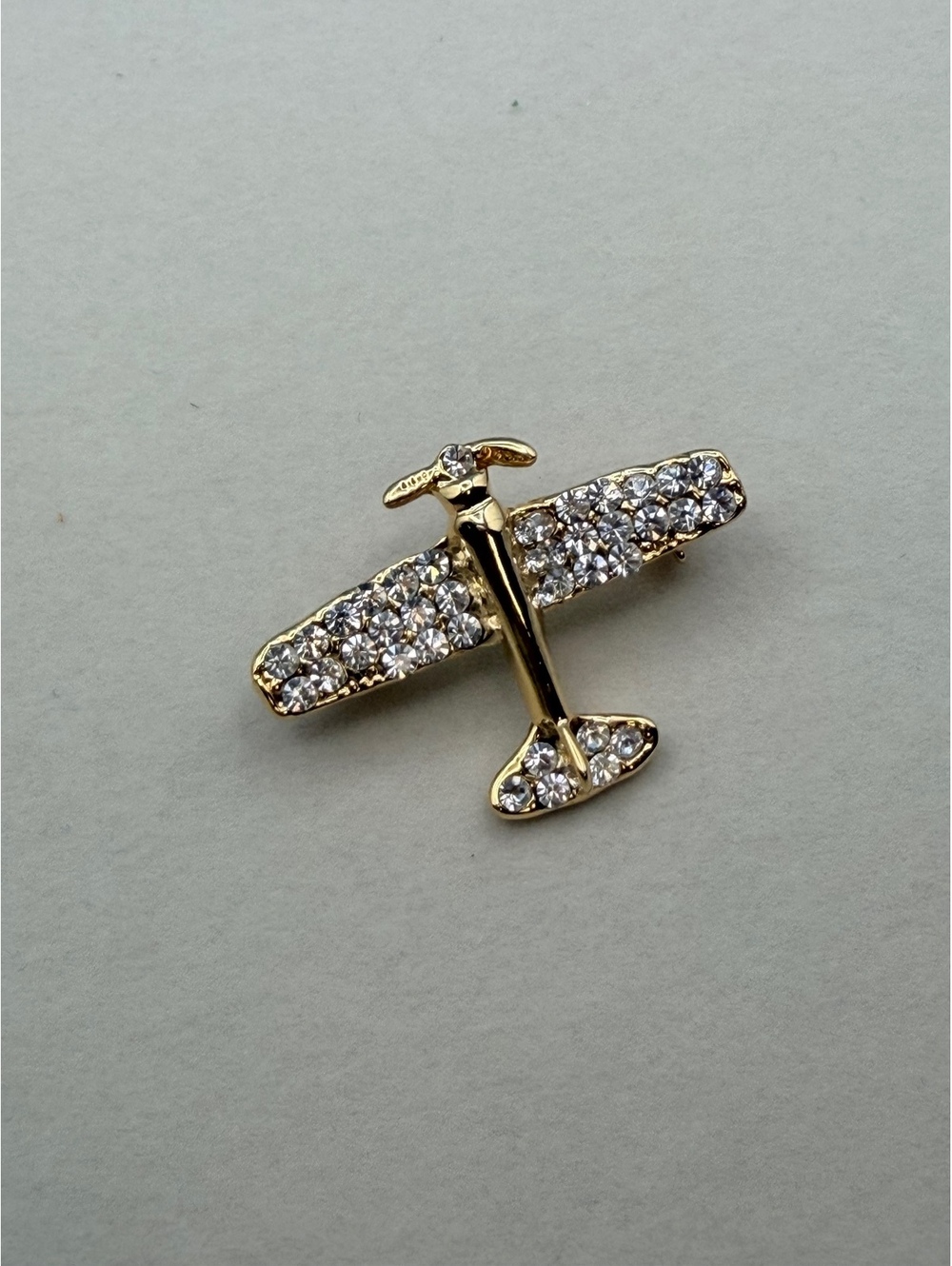 Gold tone rhinestone airplane brooch